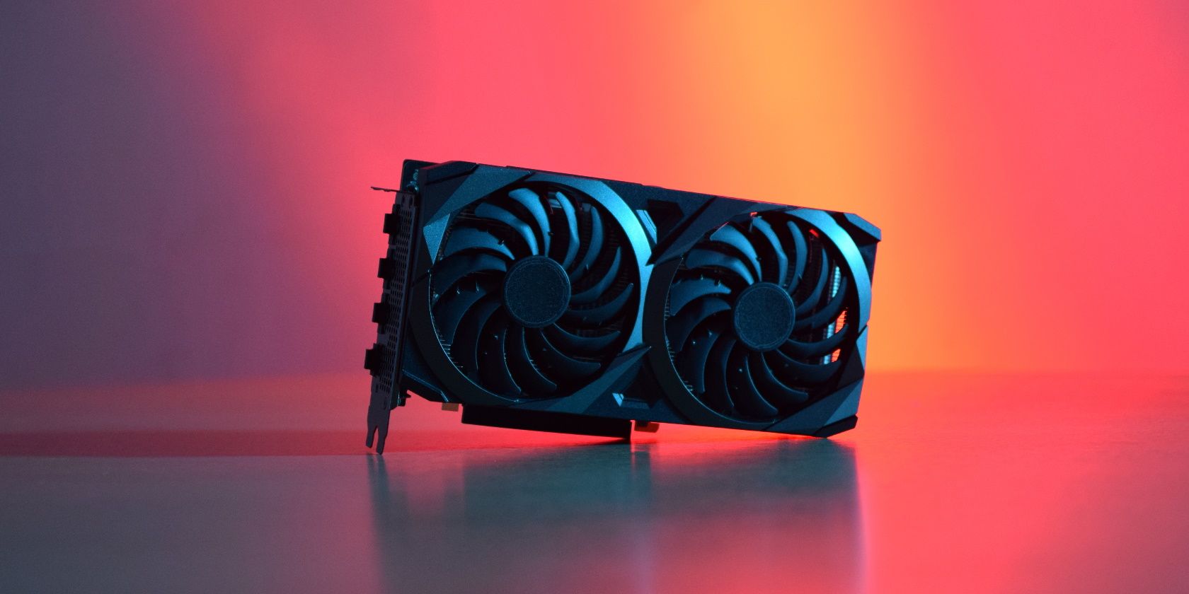 Black graphics card with two fans, on a wooden table, with red and blue lighting