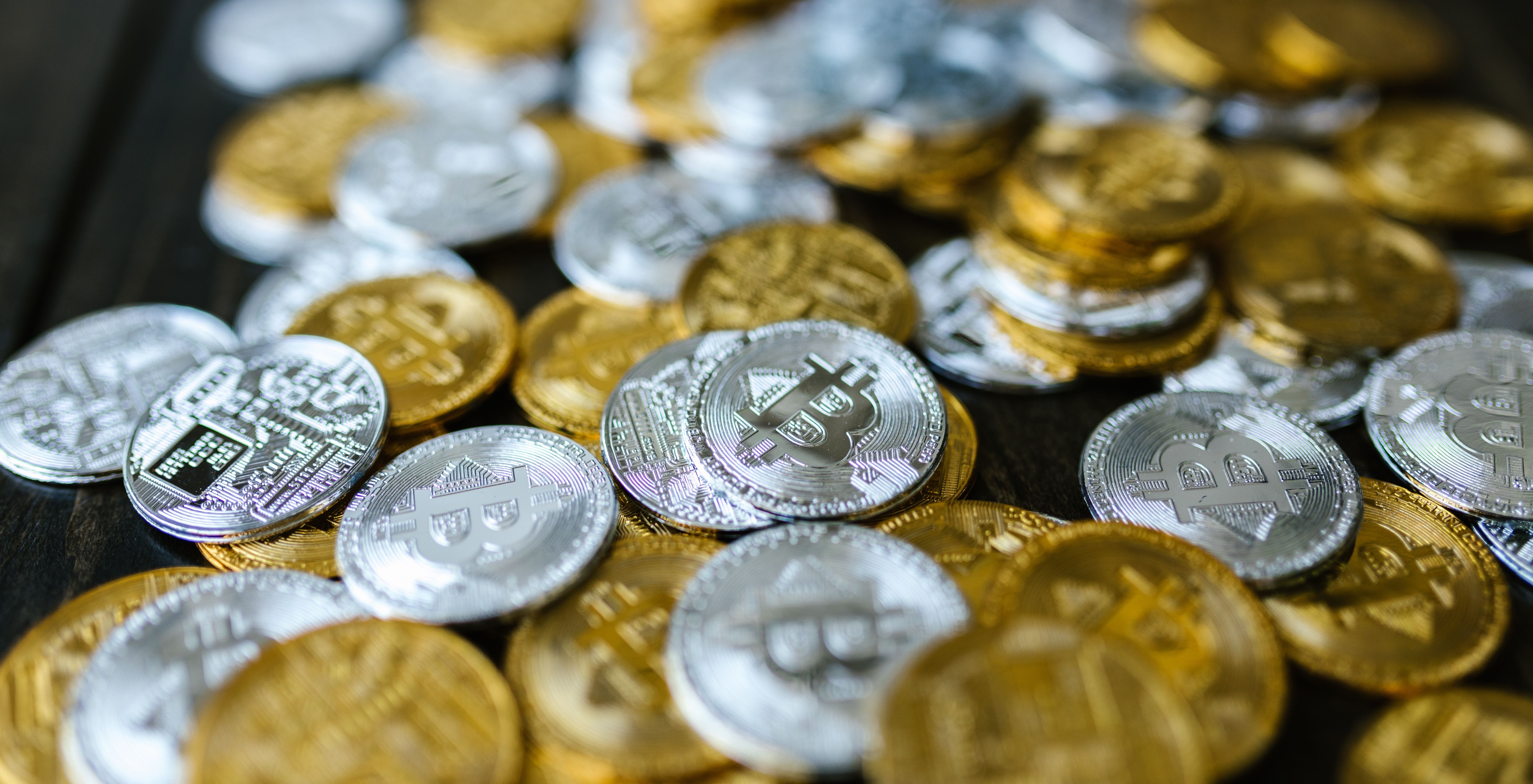 gold and silver bitcoins on table
