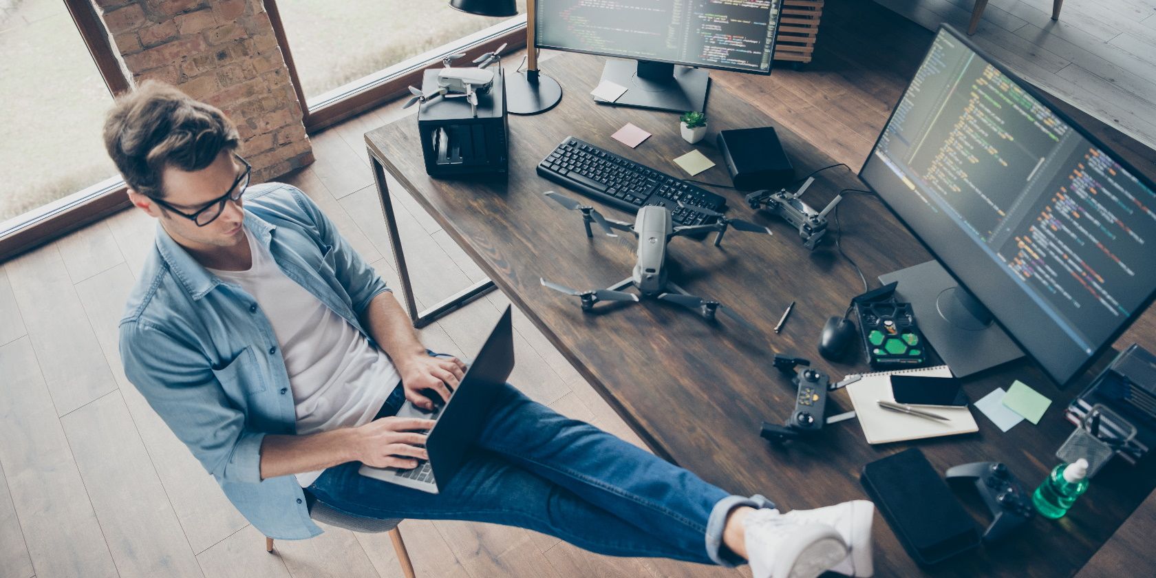 Top above high angle view of his he nice attractive focused skilled guy geek typing coding web development remote support security safety at modern loft industrial home office work place station