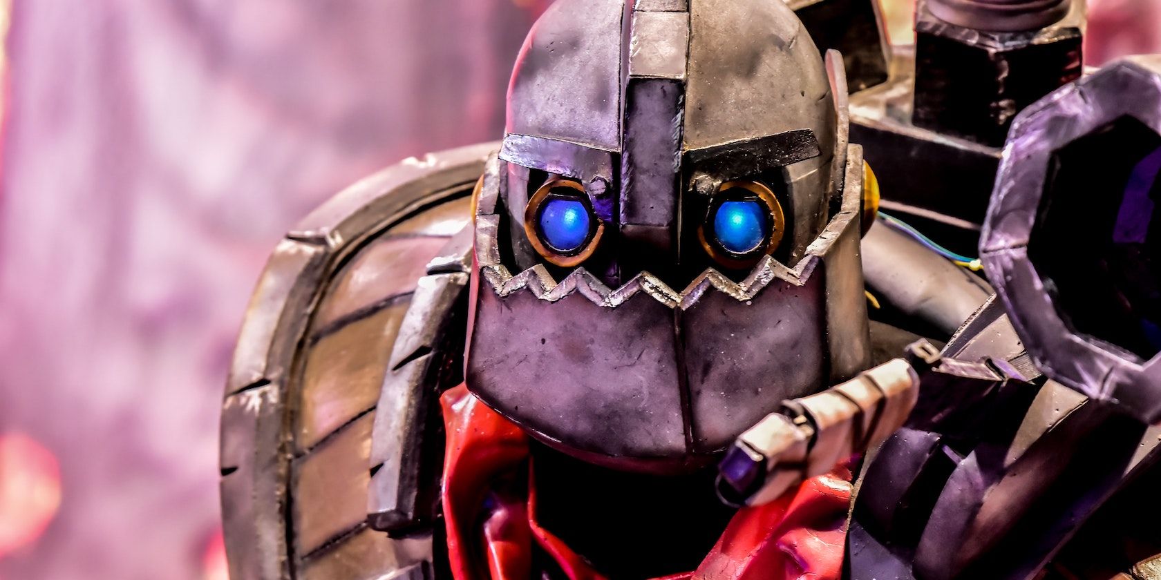 A close up shot of an armoured cosplay with glowing blue eyes