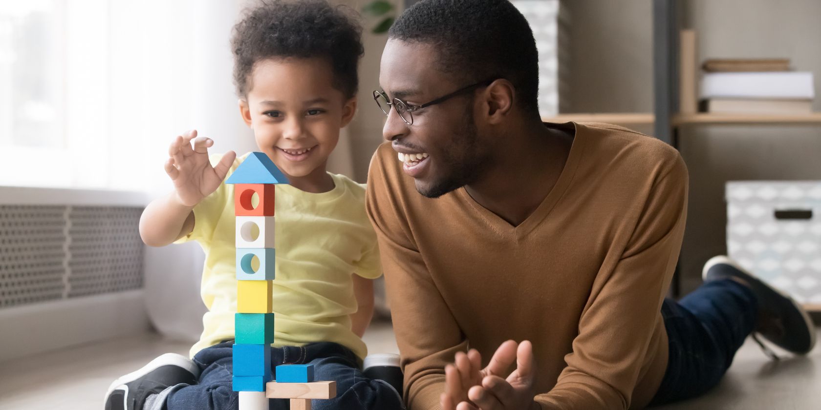 Father and child building blocks
