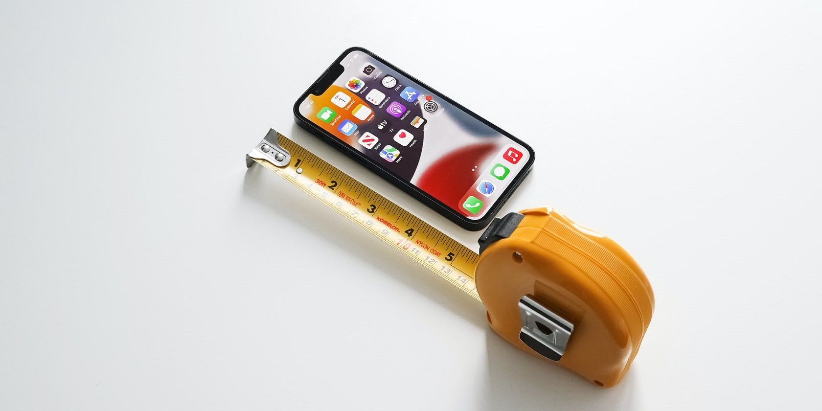 iPhone 13 mini with tape measure