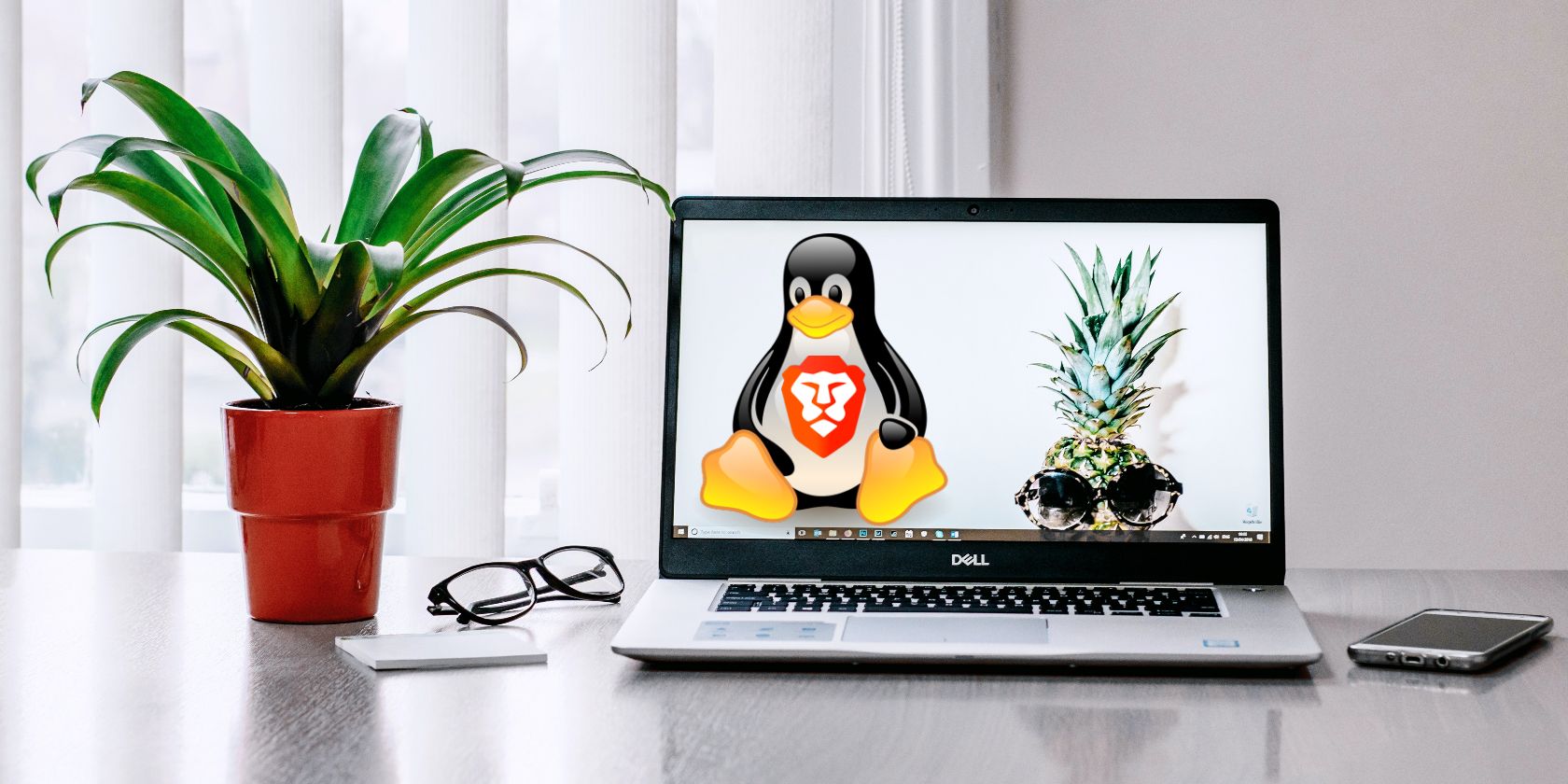 laptop with Linux and Brave's logos embedded
