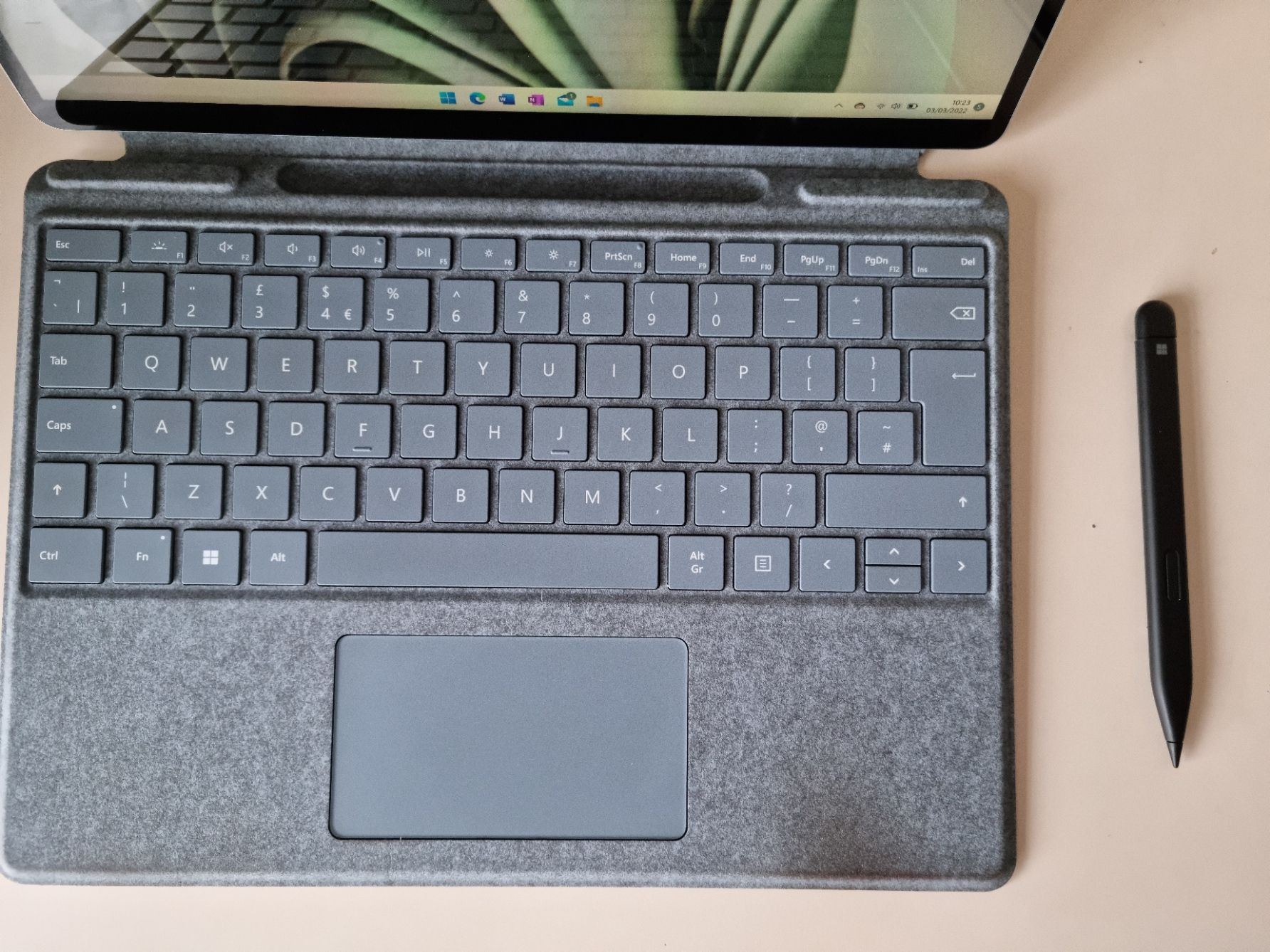 keyboard and slim pen of surface pro next to each other