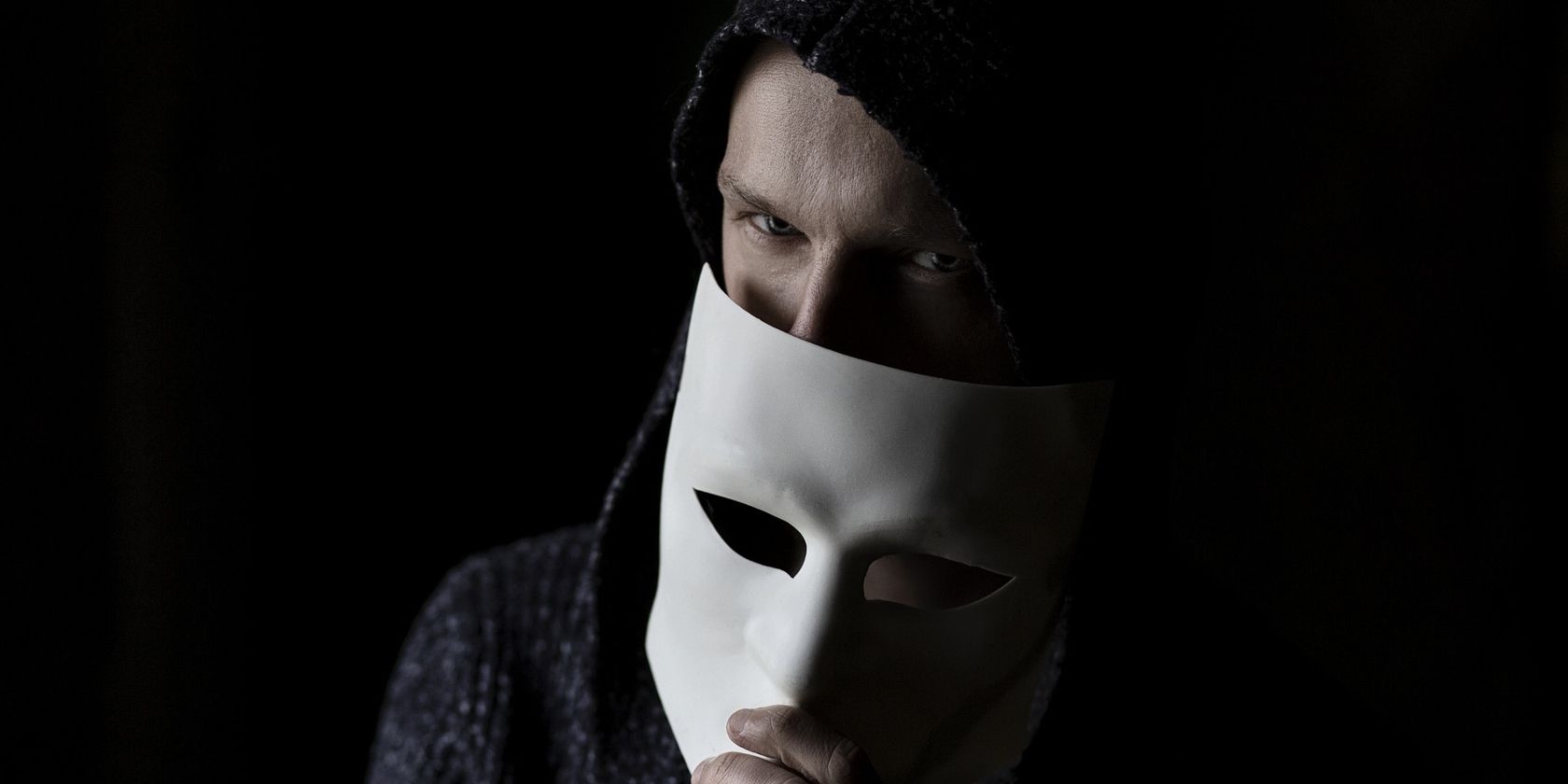suspicious man hiding behind white mask