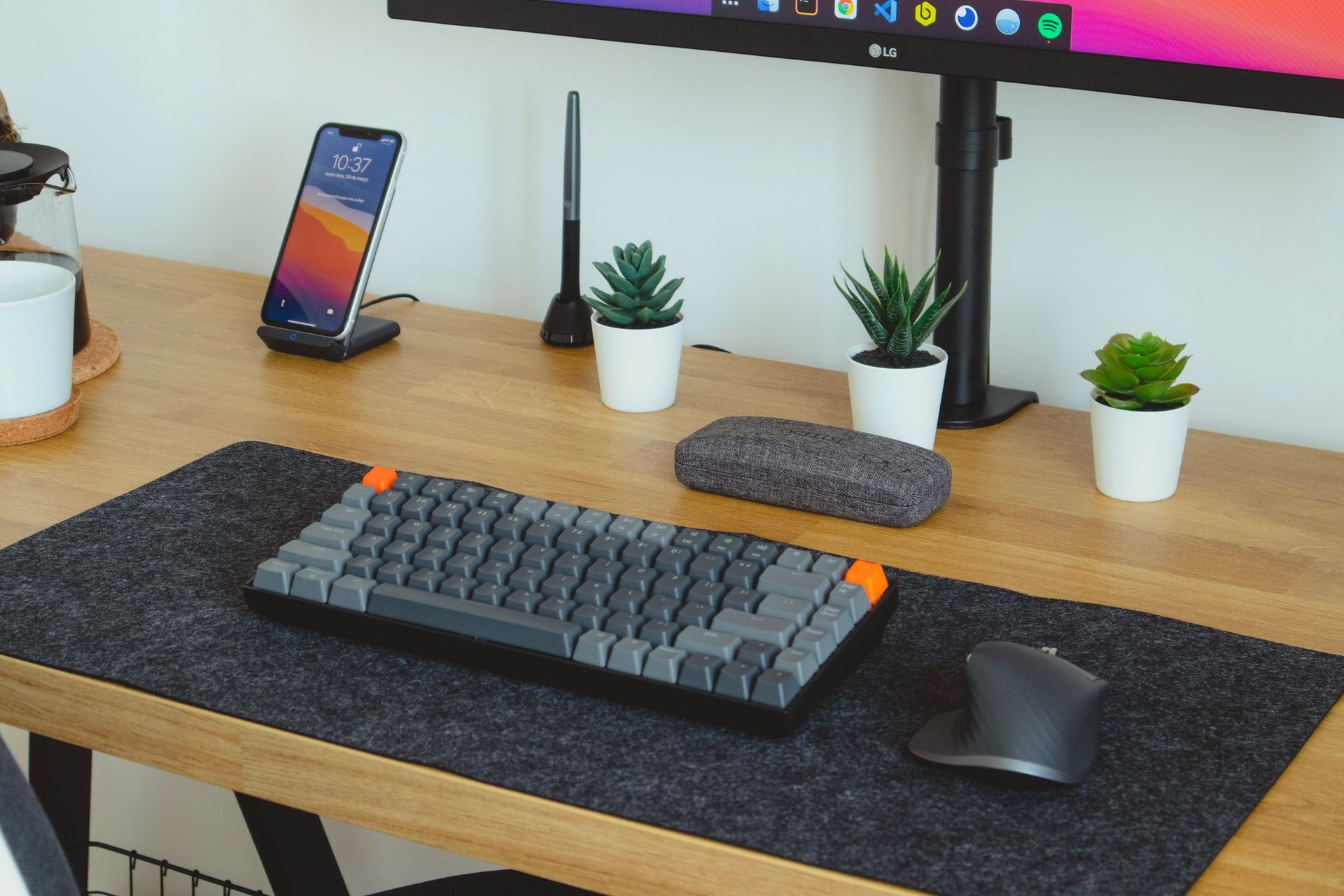 minimal custom keyboard design with desk mat, plants, mouse, and monitor, iphone