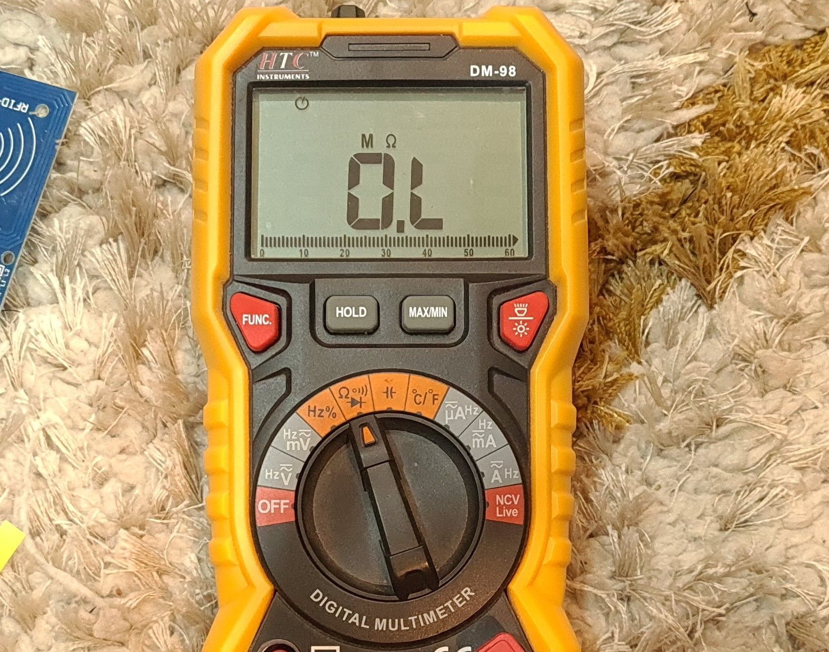 multimeter positioned to ohm resistance mode
