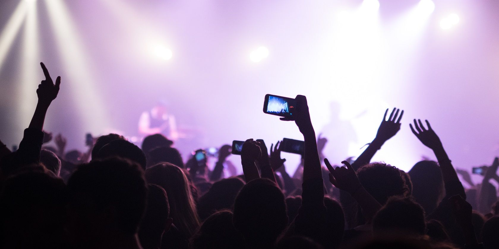 People at Concert Taking Photos With Their Smartphones