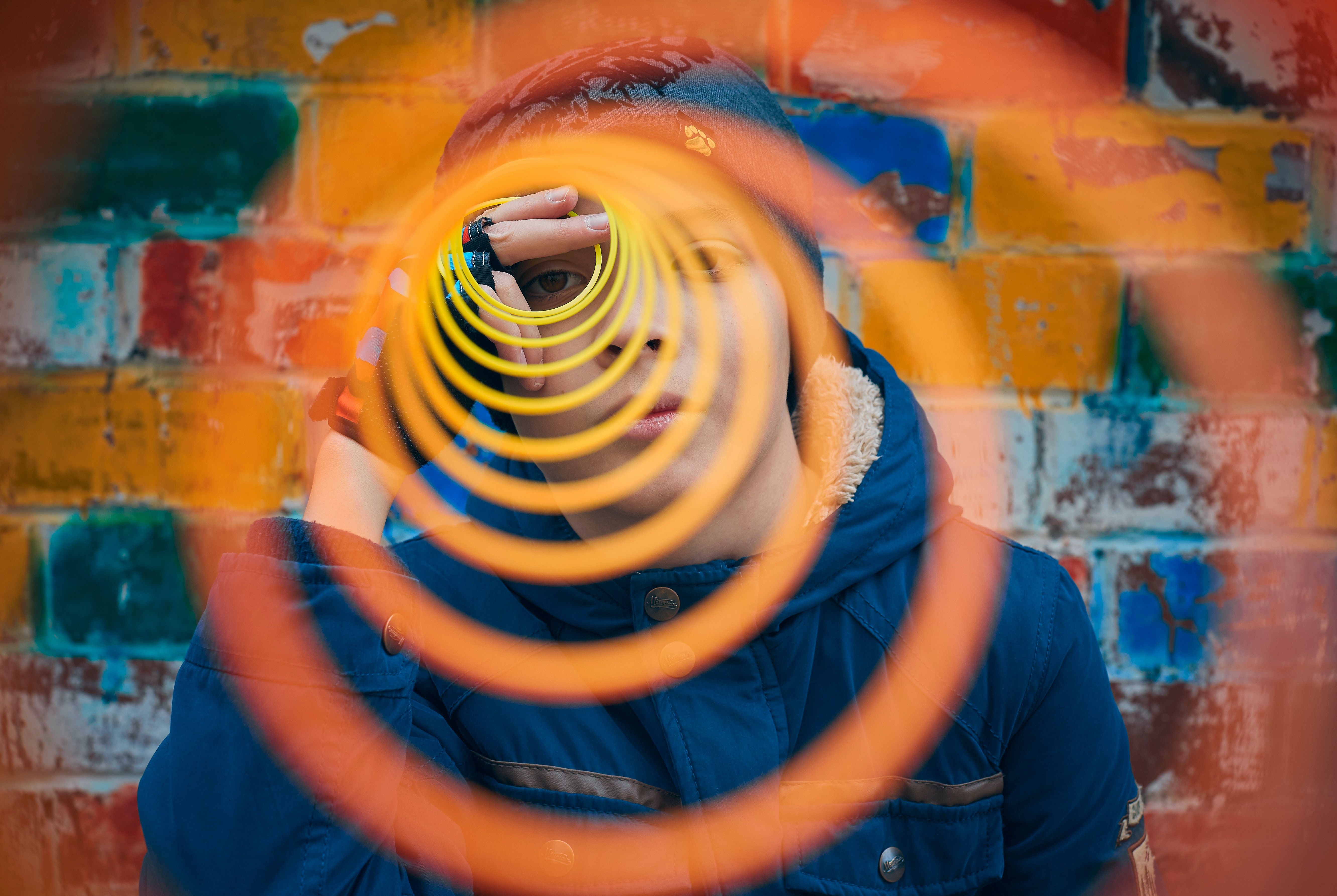 boy with an orange spiral unfolding in front of him