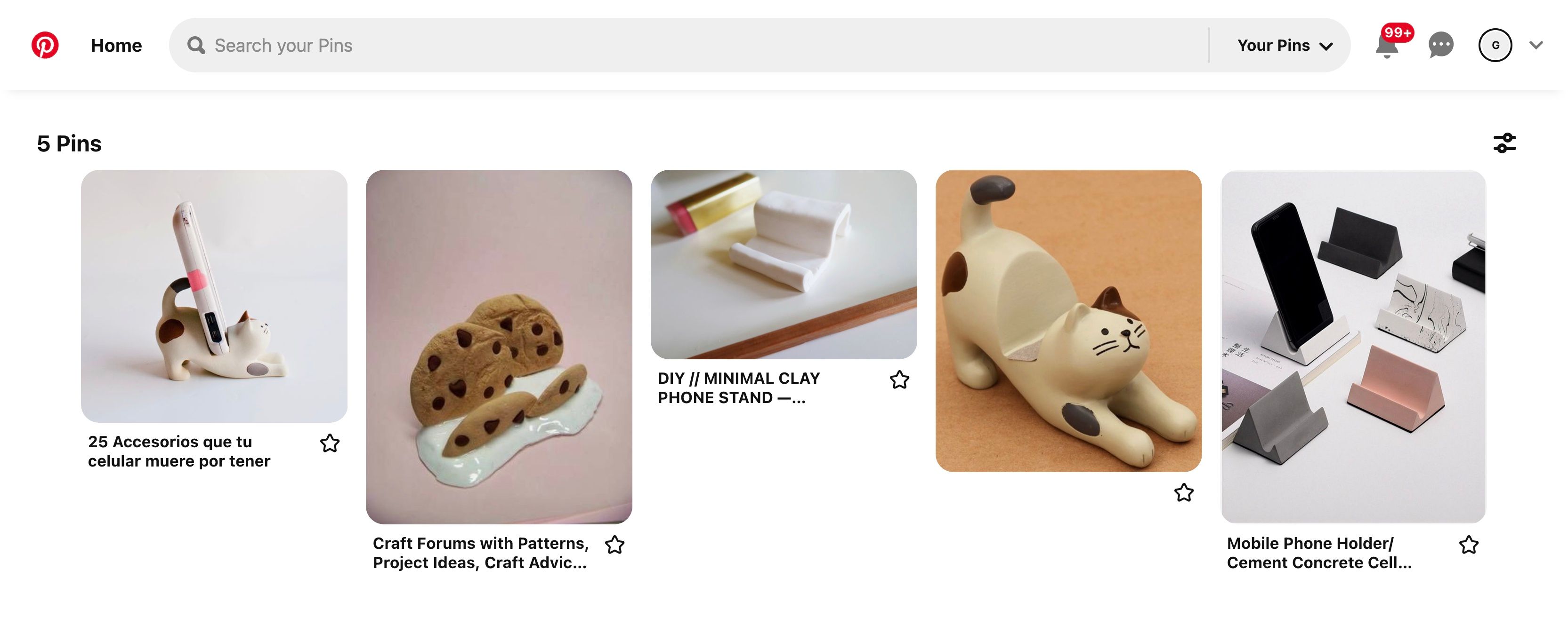 A screenshot from the website Pinterest showing different phone stands such as a stand in the shape of a cat, some chocolate chip cookies, and other geometric shapes