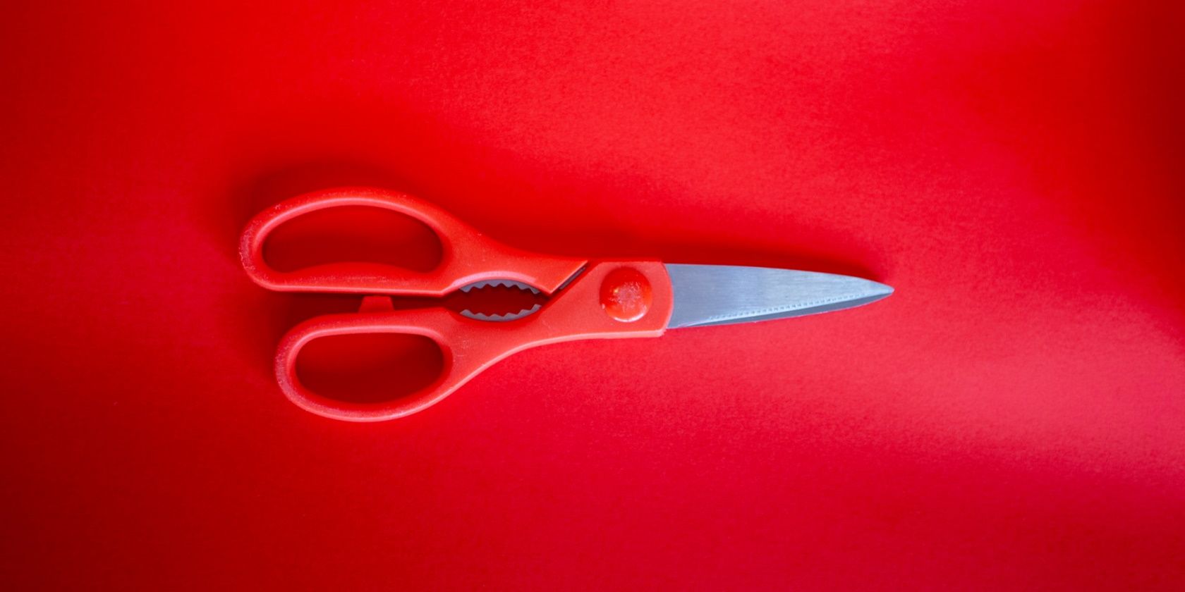 red scissors on a red background