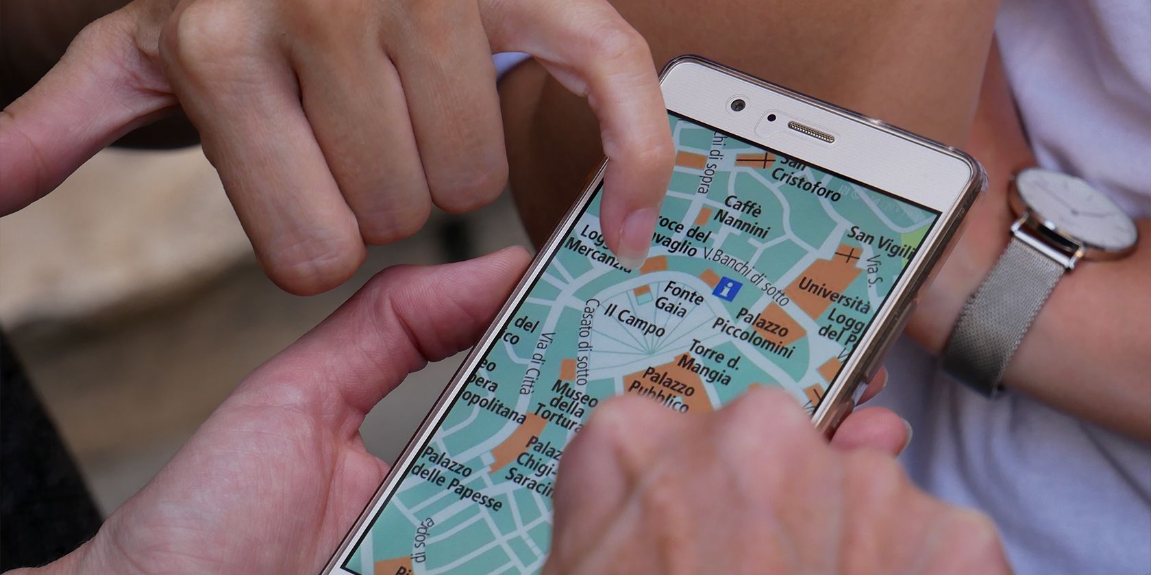 two people finding a location on a map app