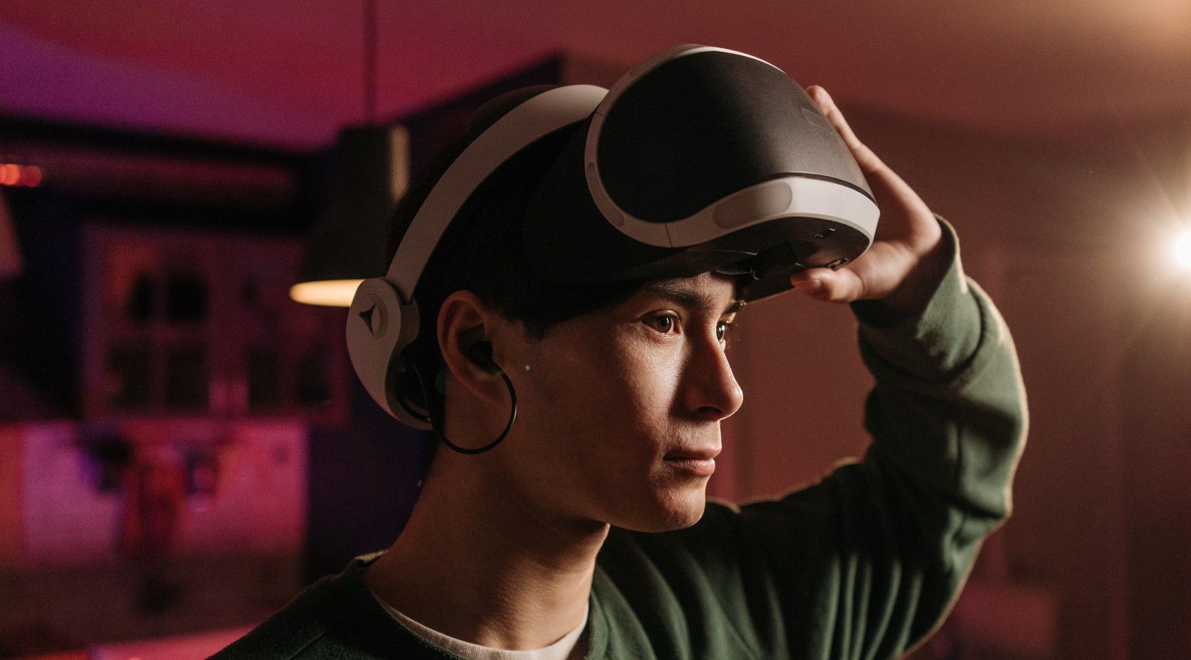 Man holding virtual reality headset above eyes