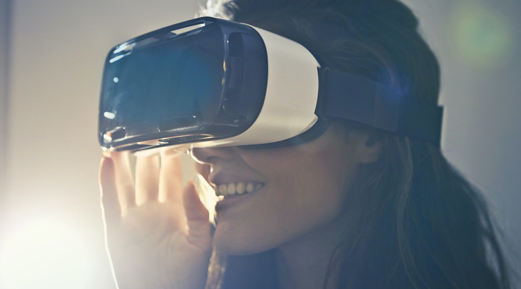 woman smiling while wearing virtual reality headset