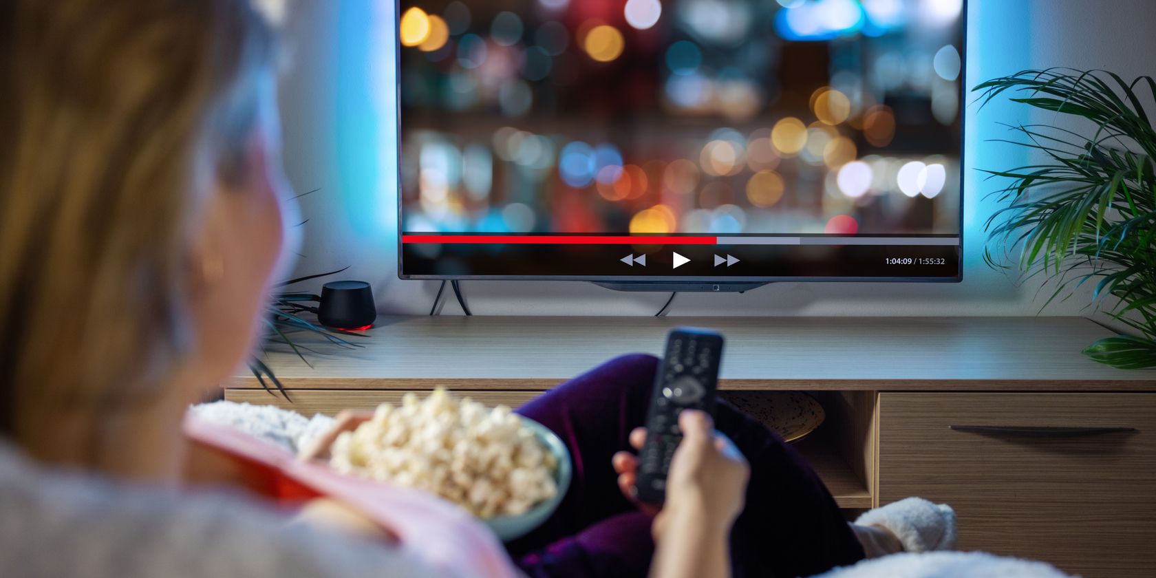 woman on couch with netflix on TV