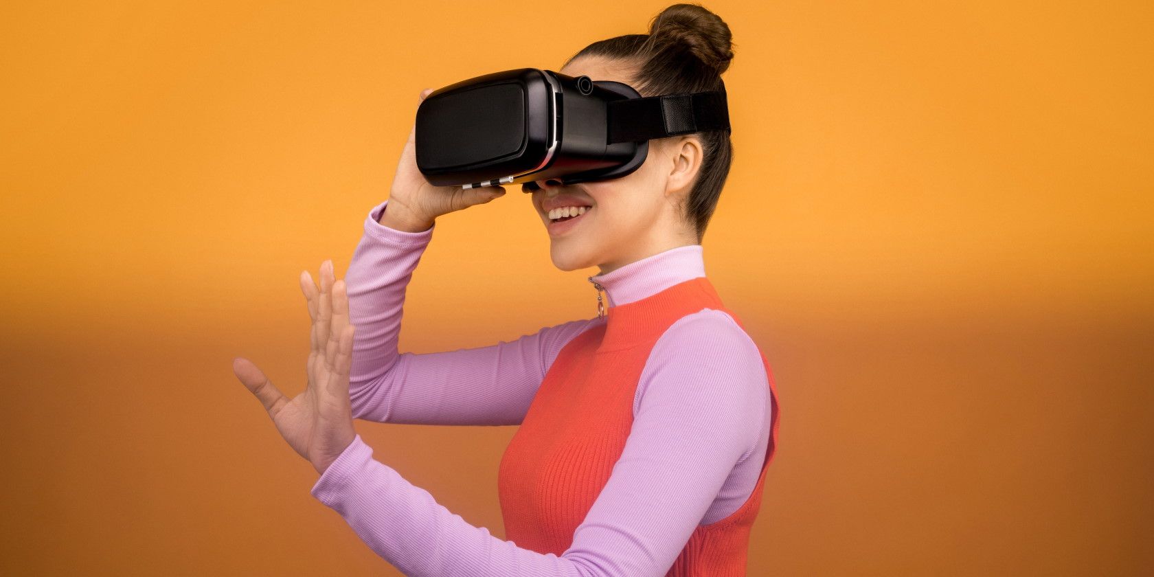 Woman smiling while wearing black virtual reality headset