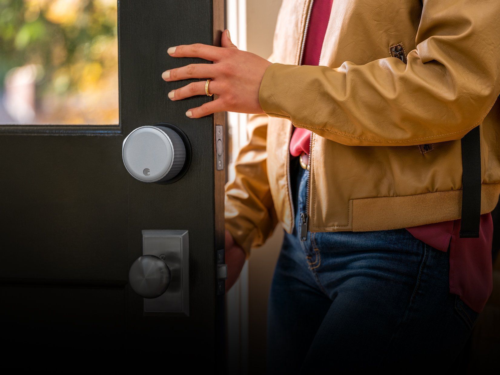 Woman entering home with August door lock