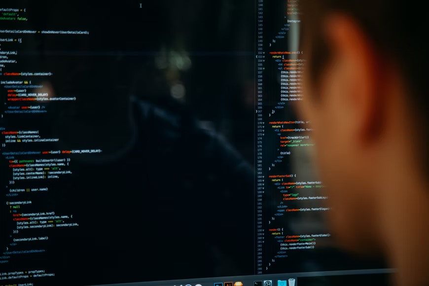 Close-up of a person reading programming code on a monitor