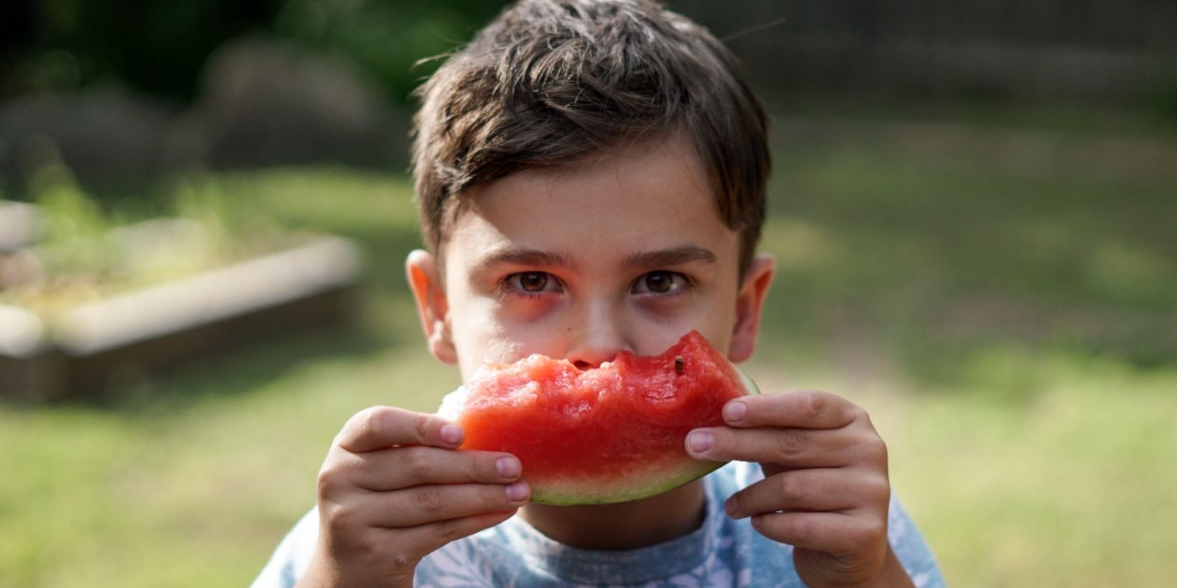 Kid eating a fruit