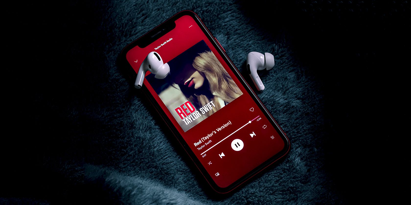 Red by Taylor Swift playing on Spotify on an iPhone