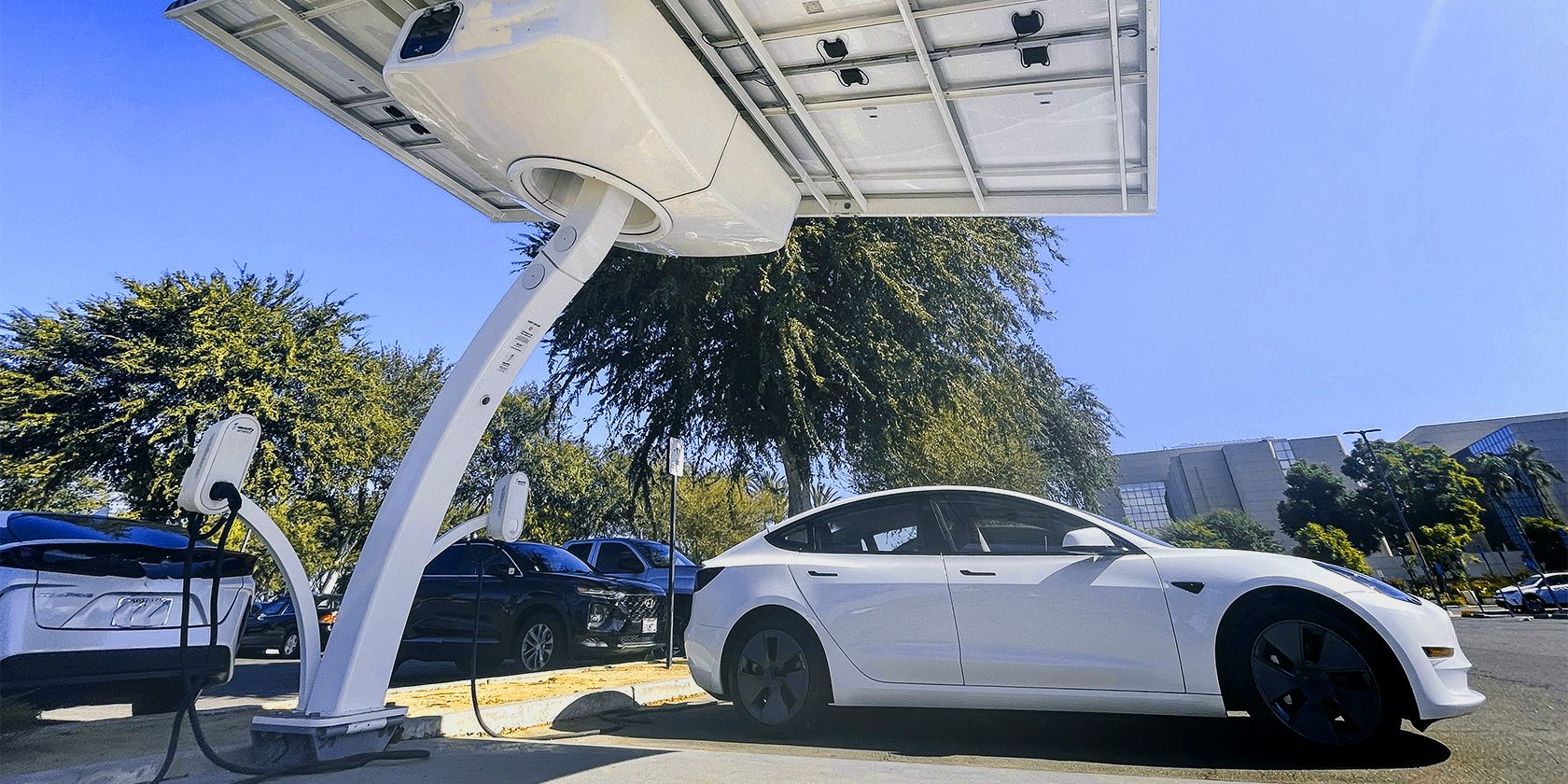 a Tesla being charged with a solar charger