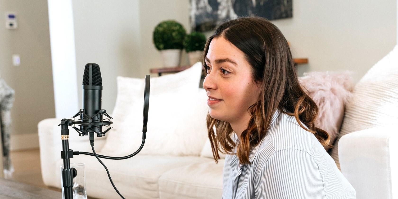 A female podcaster staring at a microphone