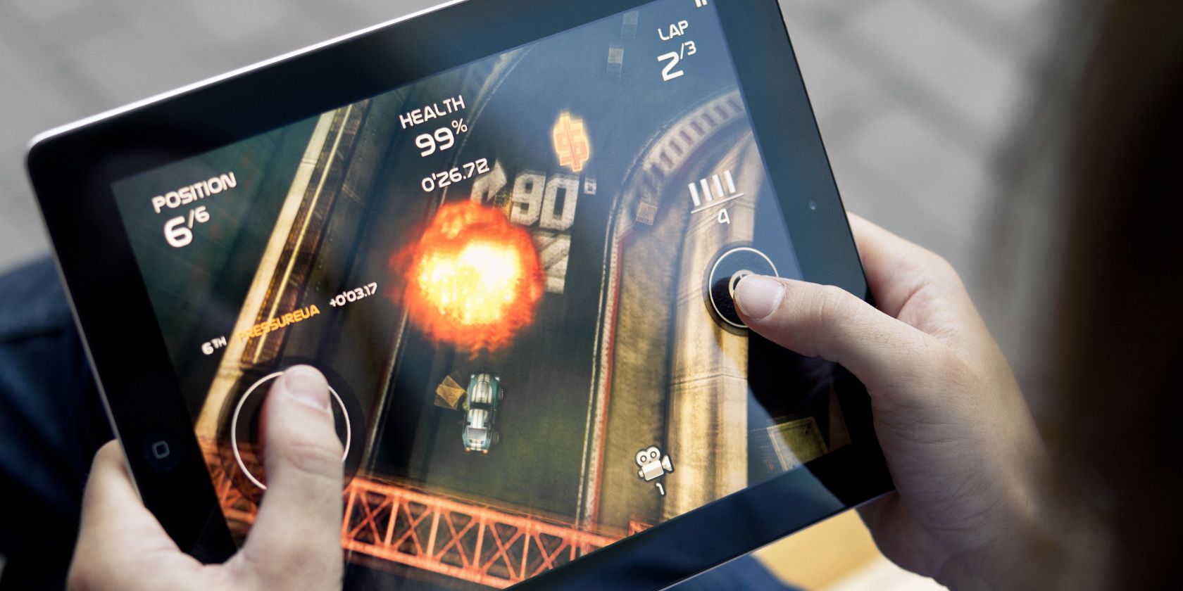 Man playing in Death Rally game on brand new Apple iPad.