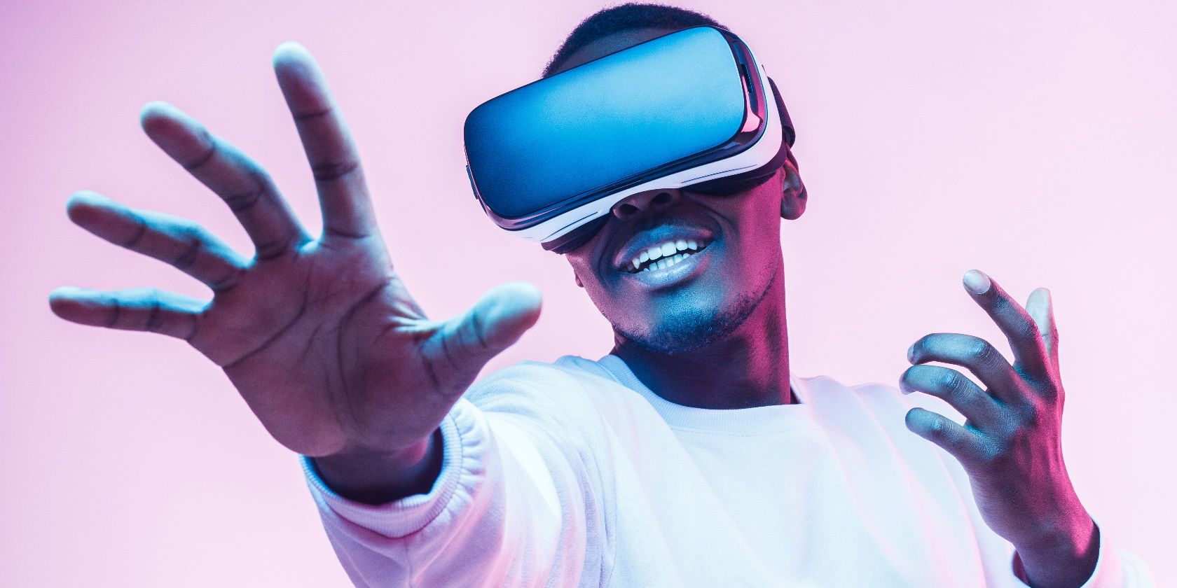 African american man in vr glasses, playing video games with virtual reality headset, trying to touch something with hand