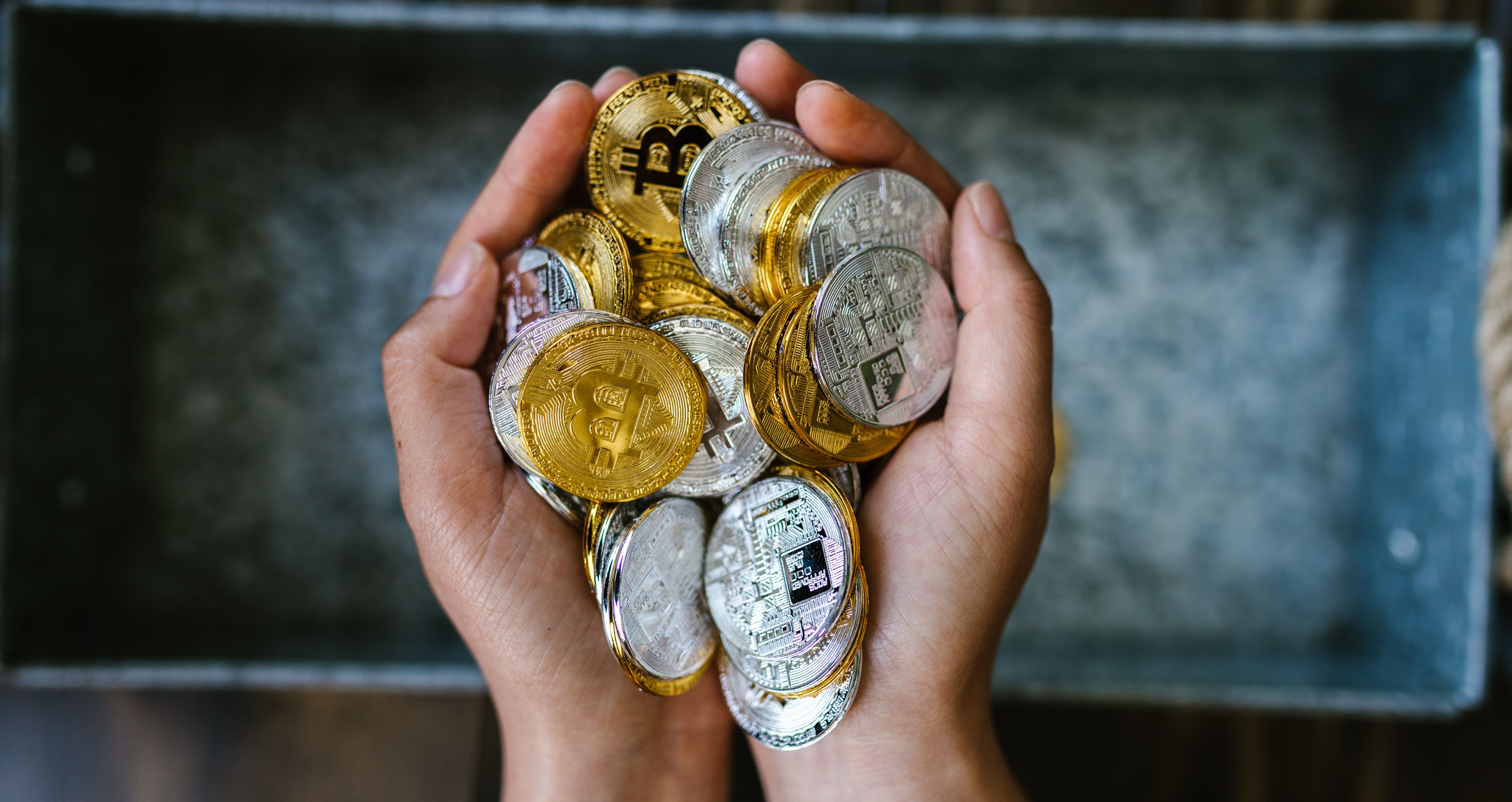 pile of bitcoins in hands