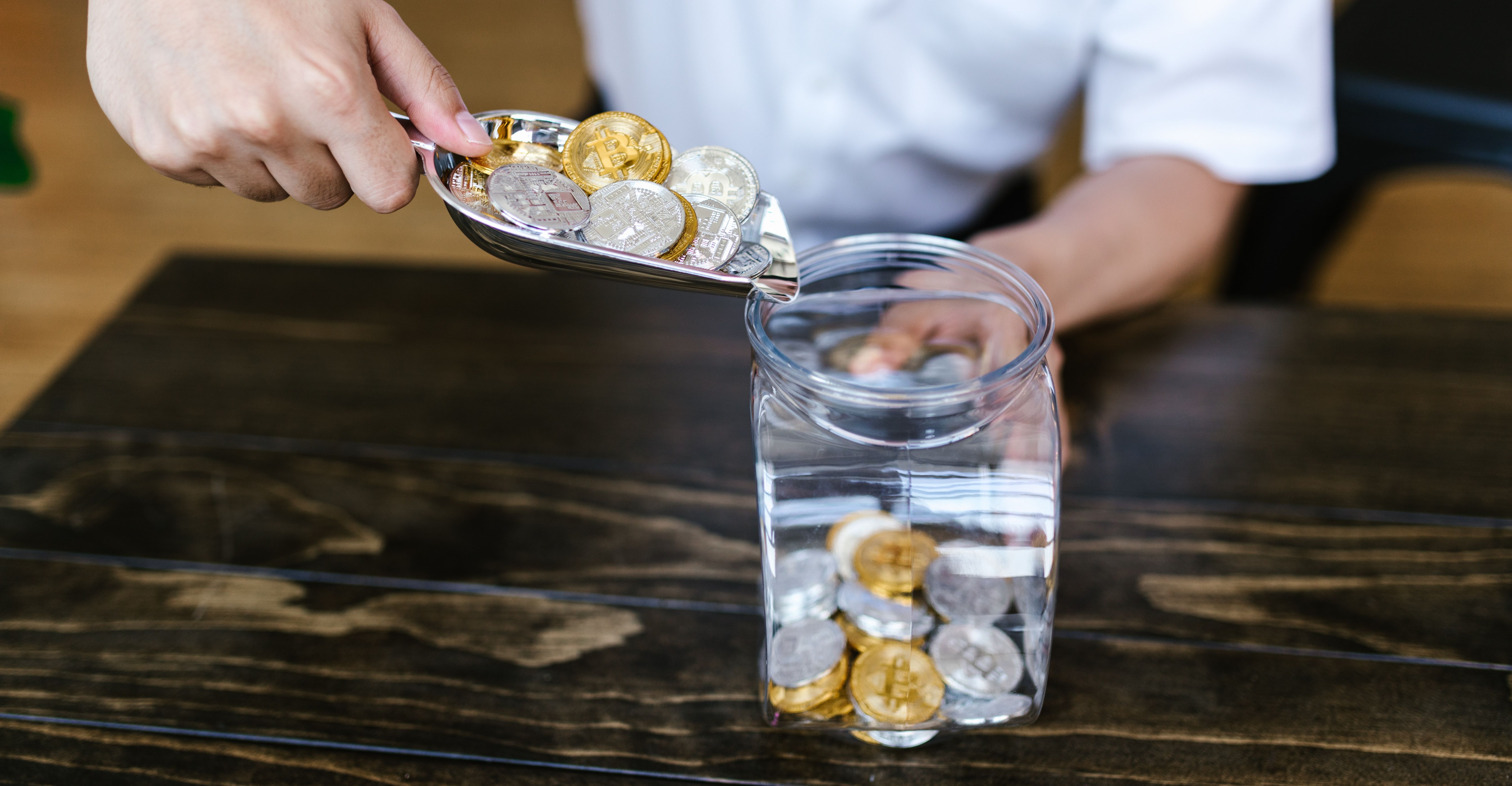bitcoins being poured into jar