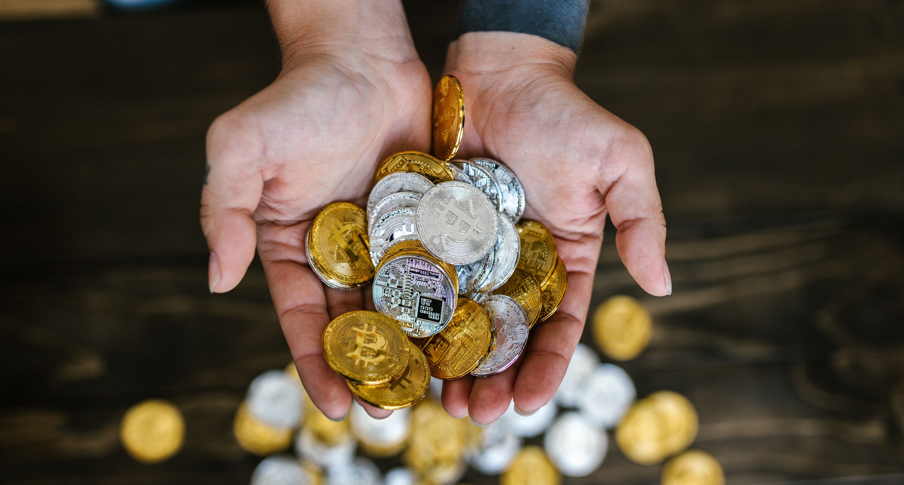 gold and silver bitcoins in hands