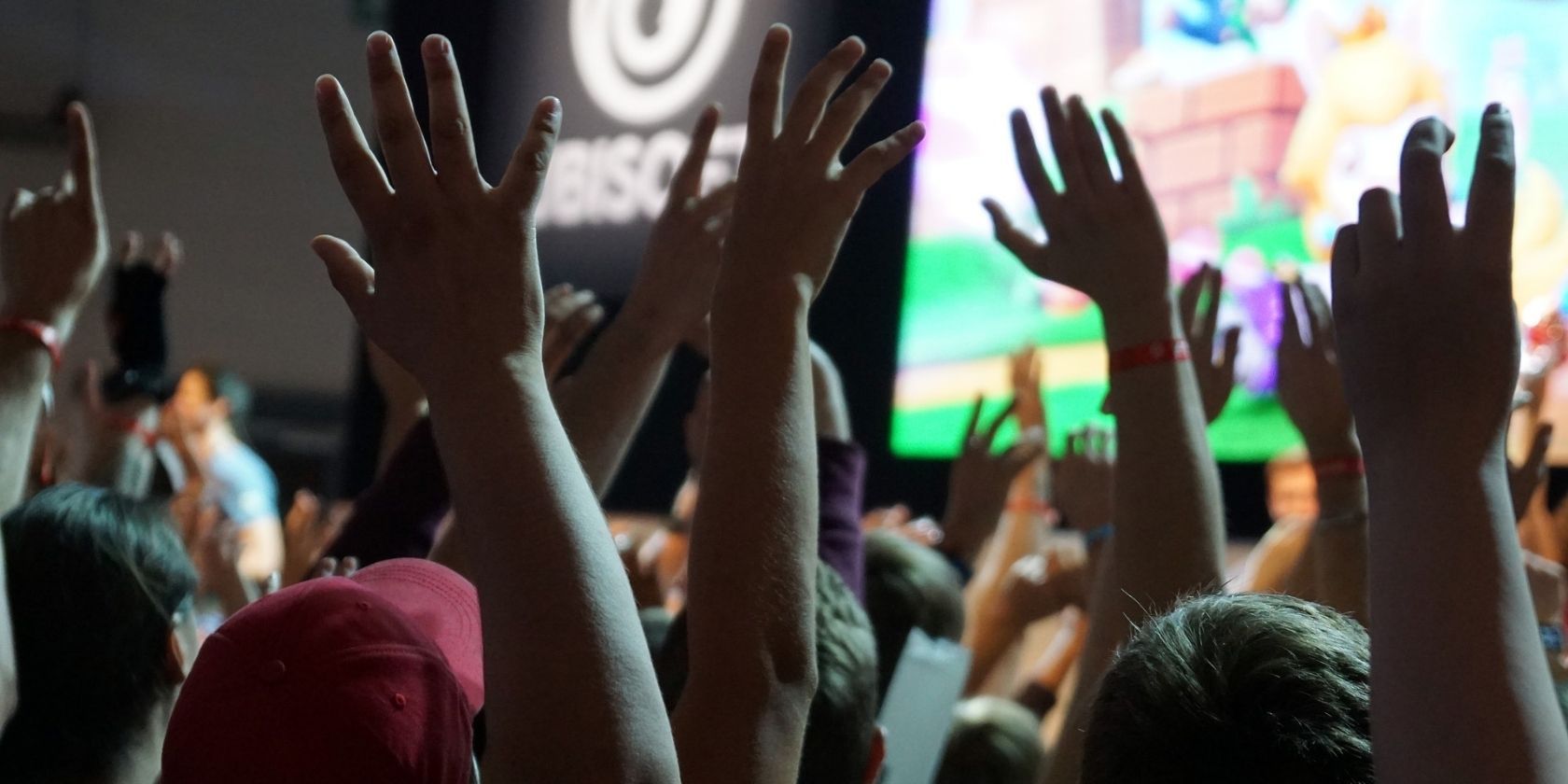 A crowd of people cheering at a Ubisoft event.