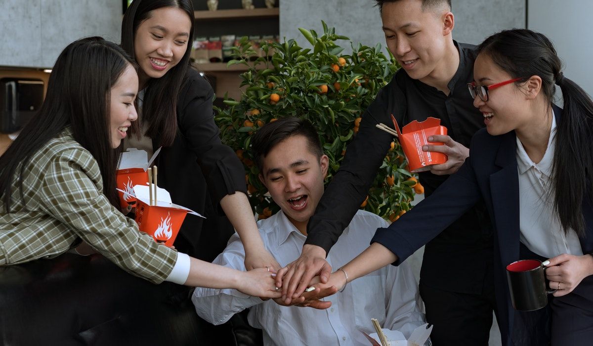 A group of employees stacking hands