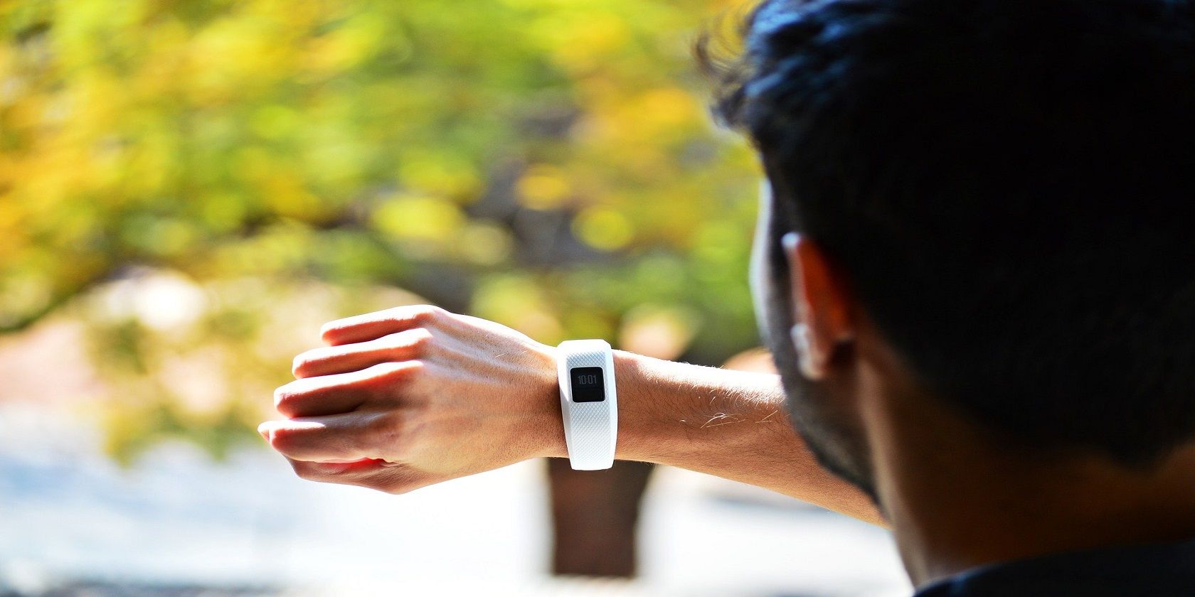 wearable fitness activity tracking device on man's wrist