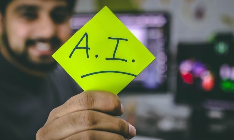 a man holding a green post-it note with the words "A.I." written on it