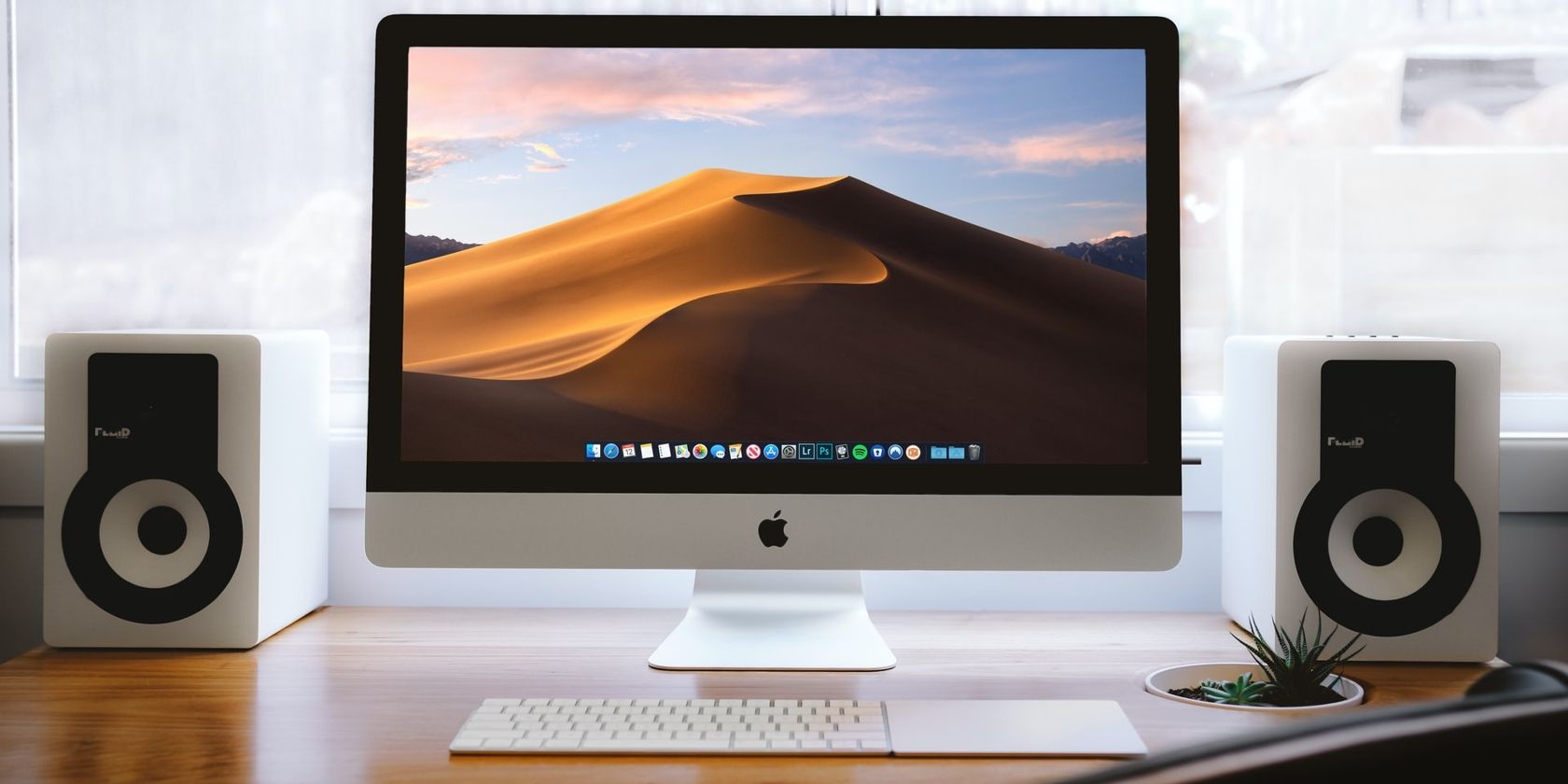 iMac on desk with speakers
