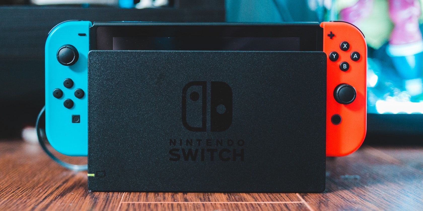 A Nintendo Switch with a blue left JoyCon and a red right JoyCon in its dock 