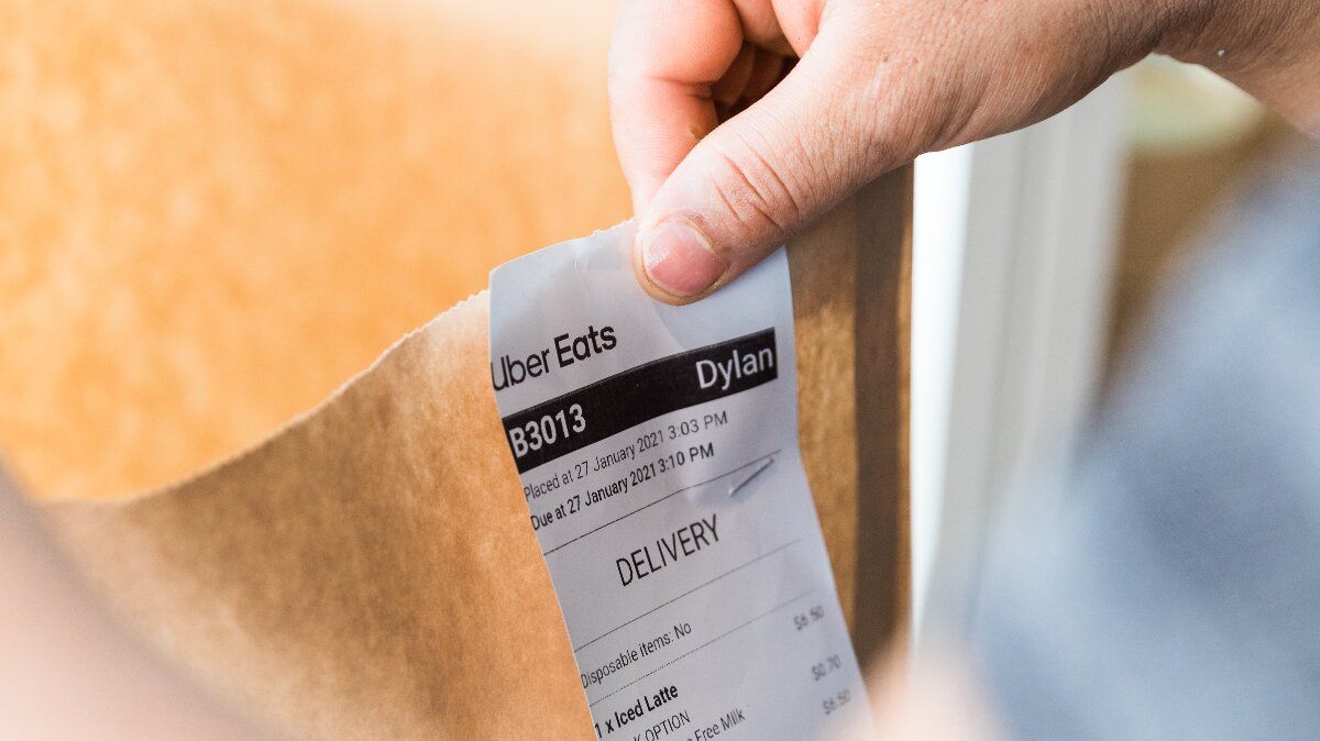 Someone holding an Uber eats delivery receipt. 