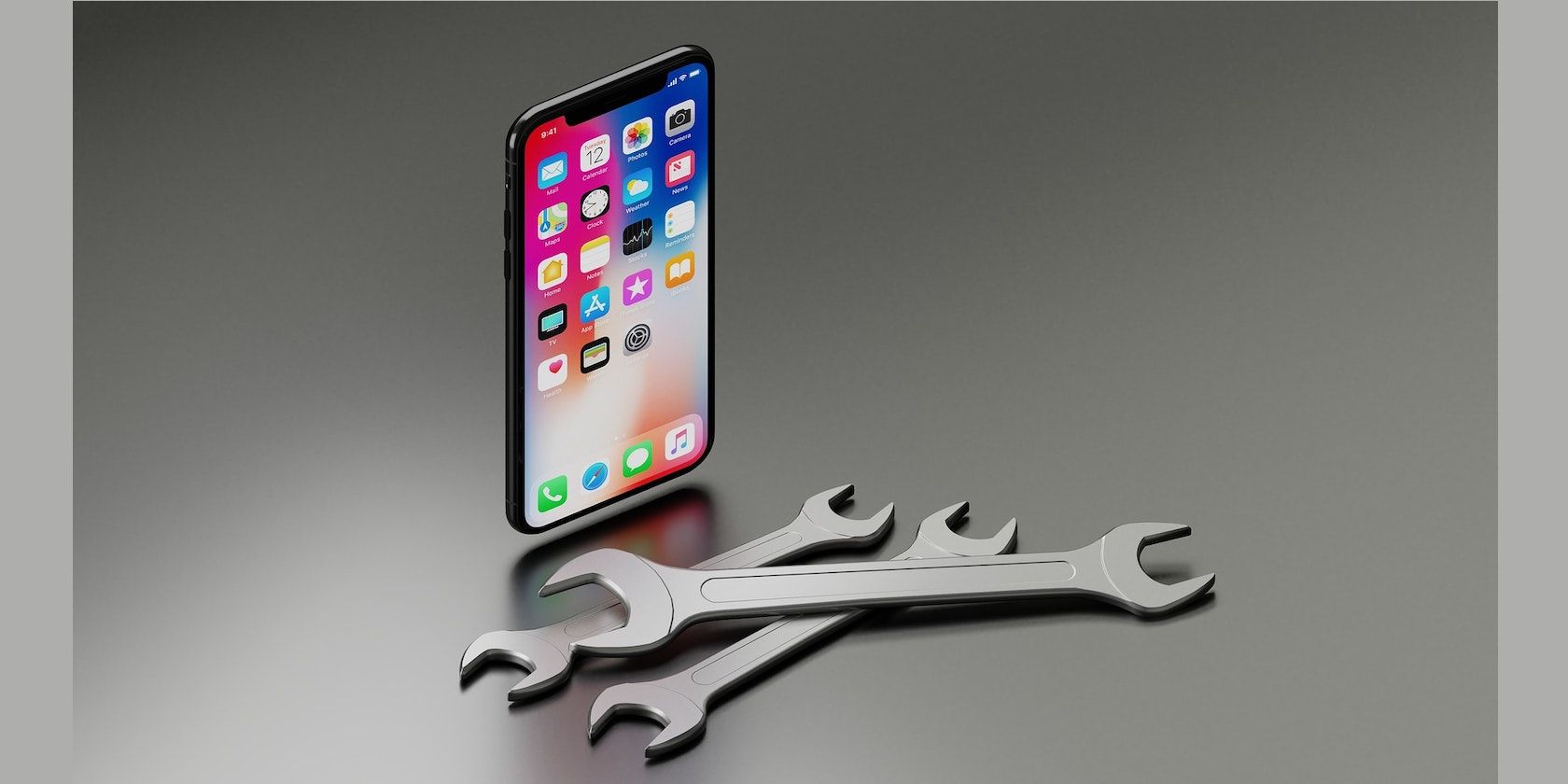 A photo of an iPhone behind a pile of spanner tools
