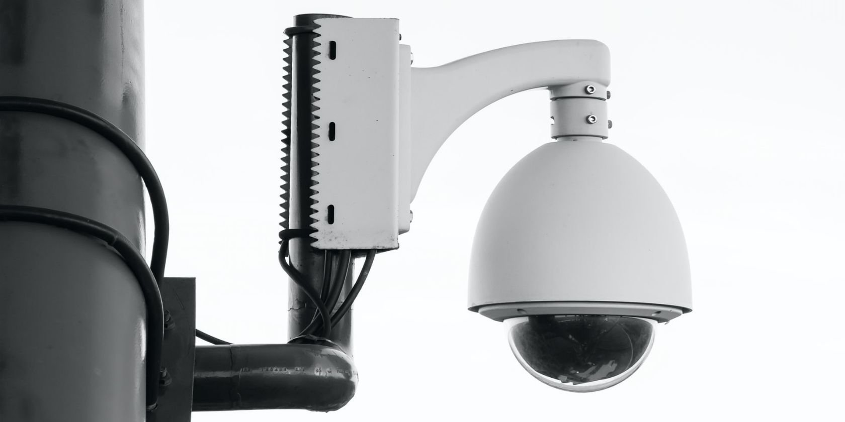 a round white security camera attached to a pole