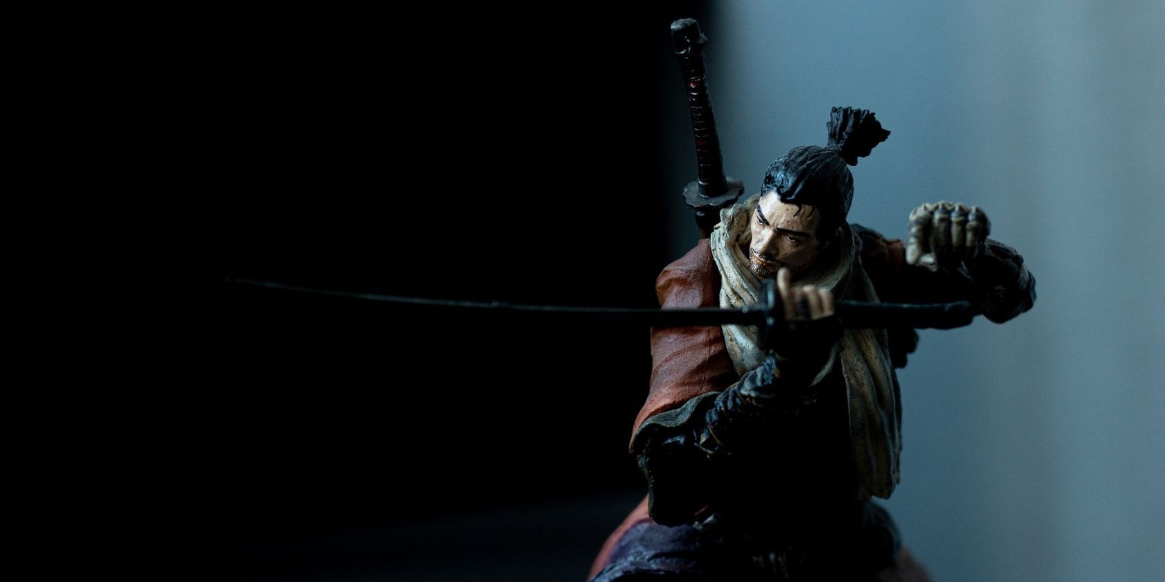 A Samurai figurine with a black background.