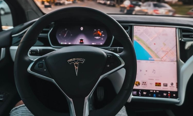 Person operating self-driving Tesla without hands on the wheel