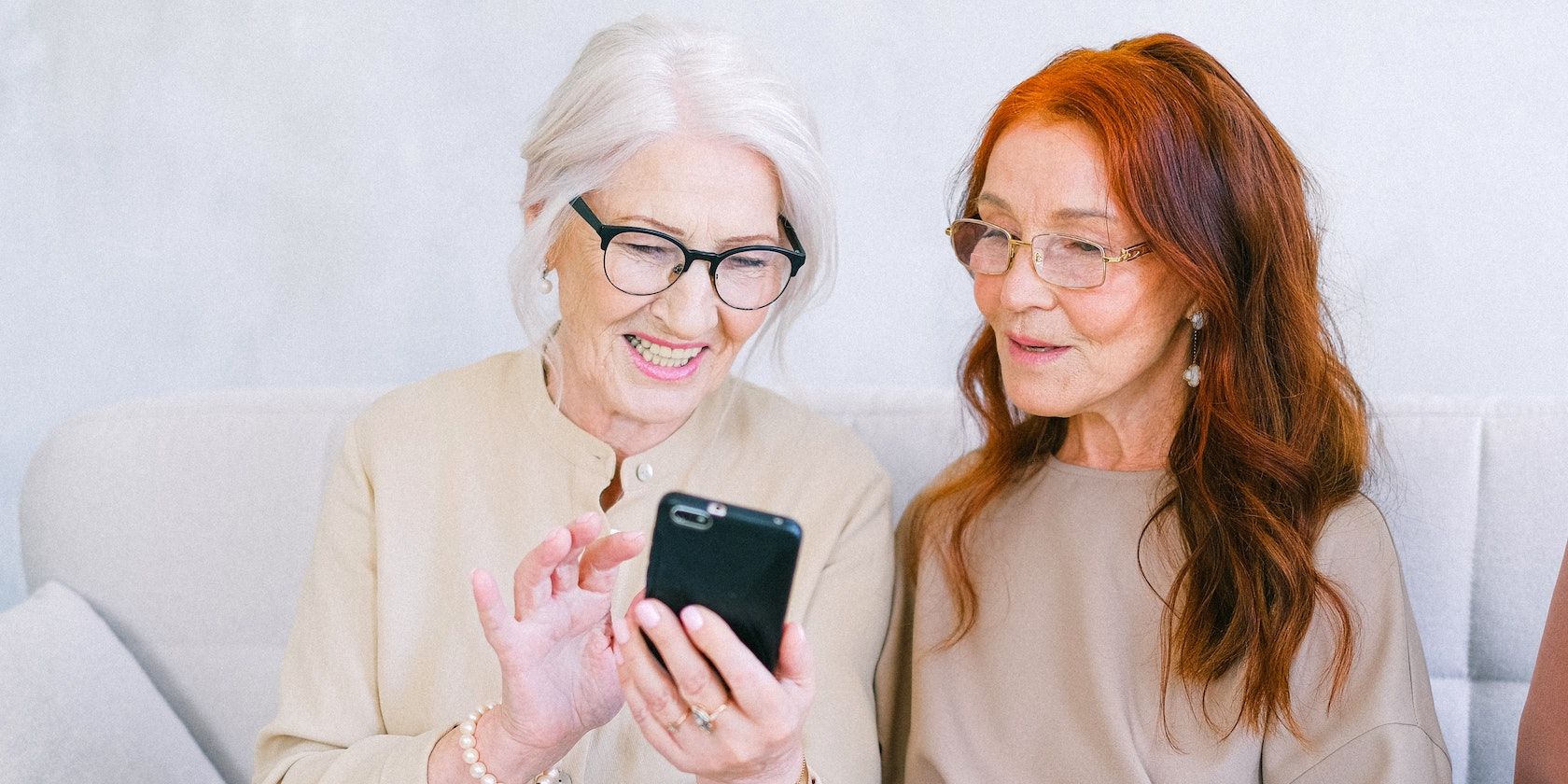 two older women looking at an iphone