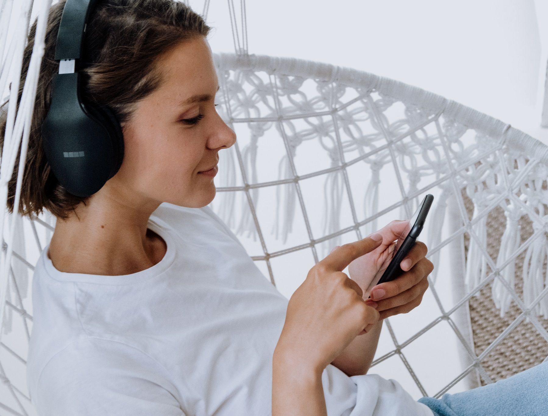 woman with headphones and phone