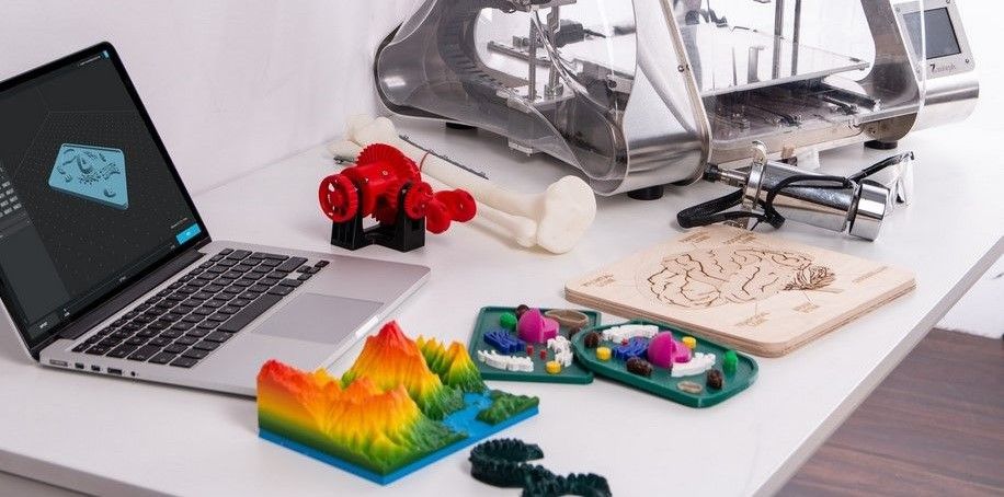 3d-printed objects and mac on desk
