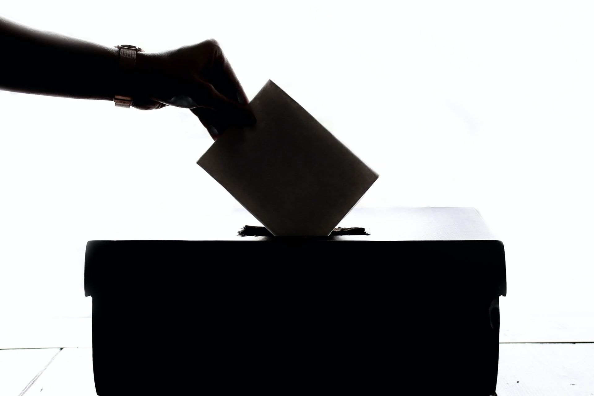 A Person Casting a Vote in Ballot Box