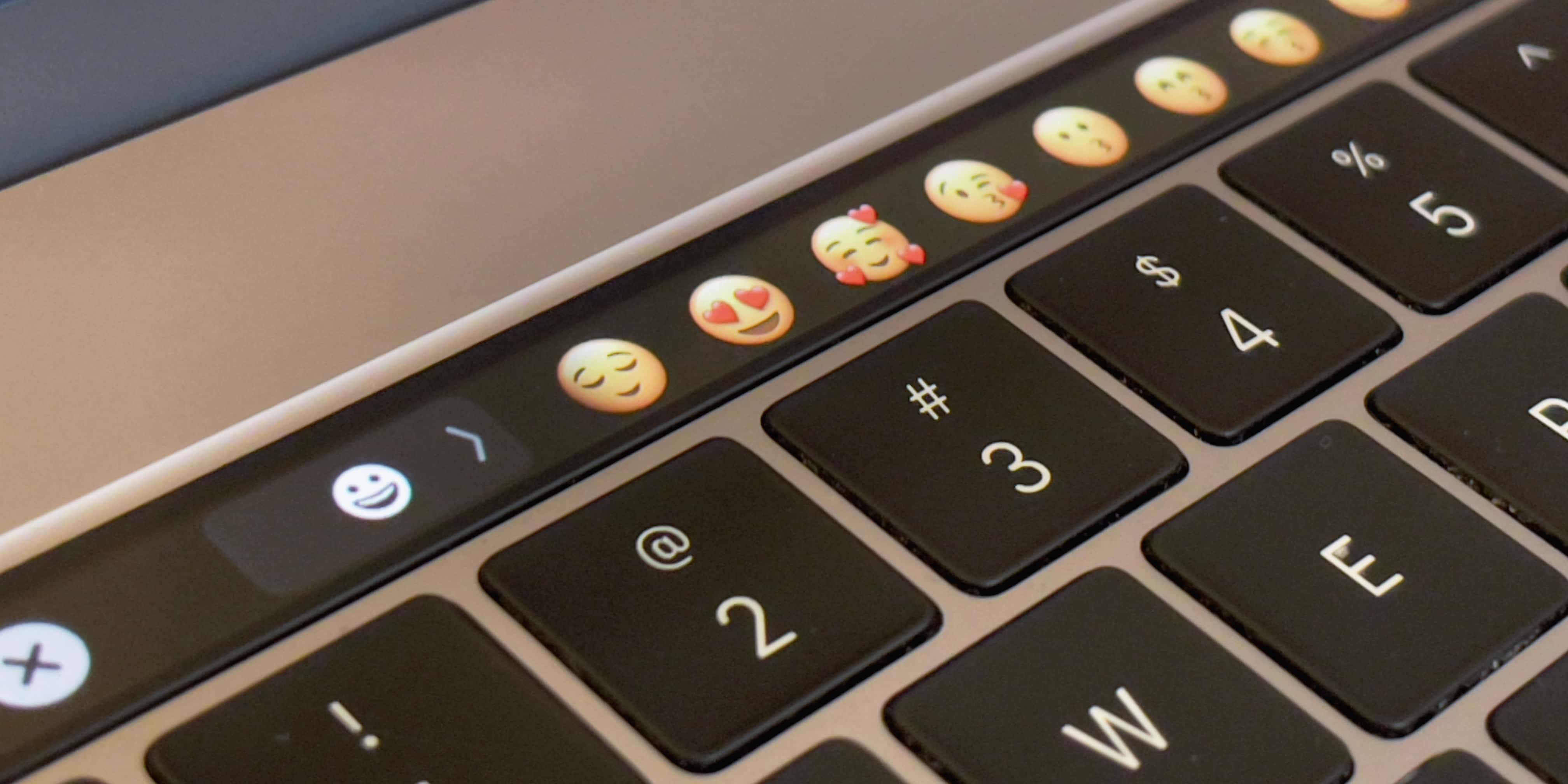 A closeup of Apple MacBook Pro's Touch Bar showcasing picking emoji in the Messages app