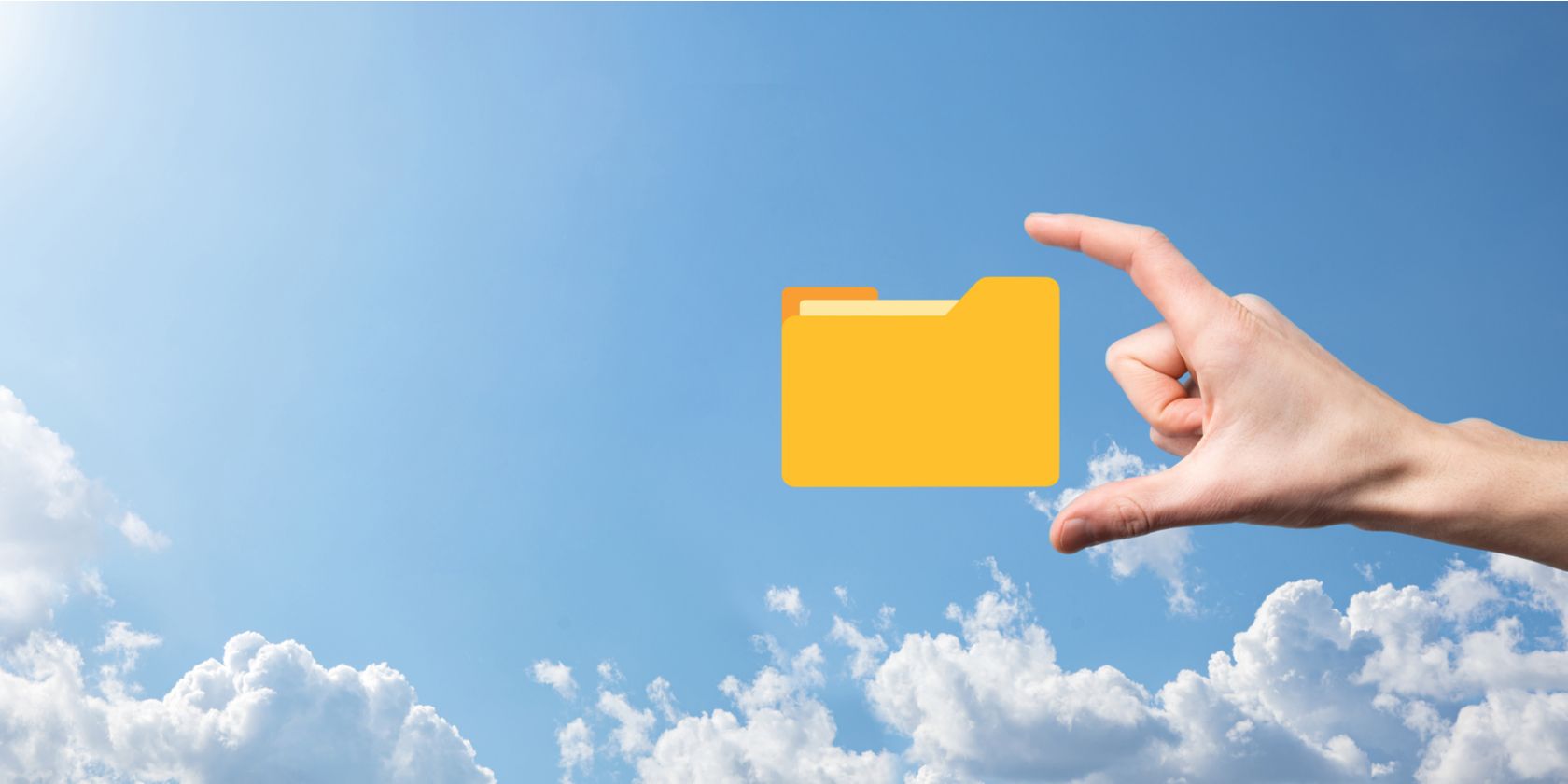 Hand about to grasp folder icon with fingers on a sky background