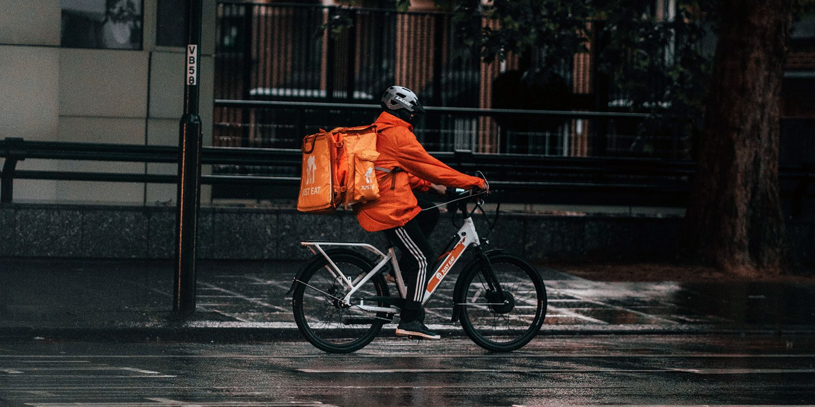 Food Delivery Biker Delivering Food in the Rain