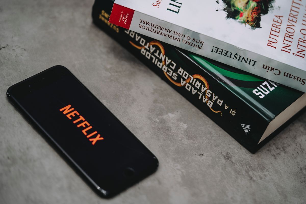 Netflix on smartphone near books